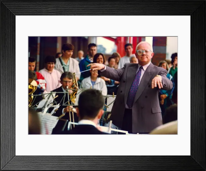 Framed Print : Actor Ken Morley hamming it up with the Eveready Brass Band when he opened by new MFI