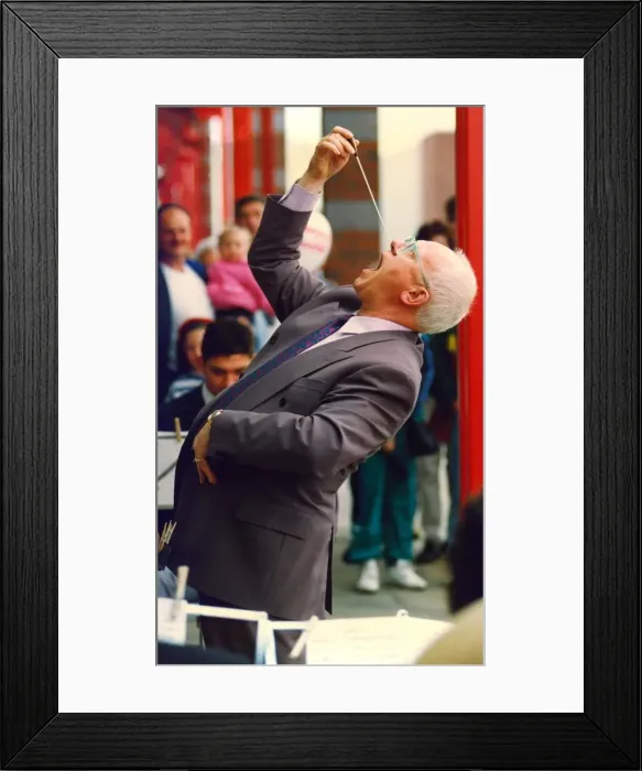 Framed Print : Actor Ken Morley hamming it up with the Eveready Brass Band when he opened by new MFI