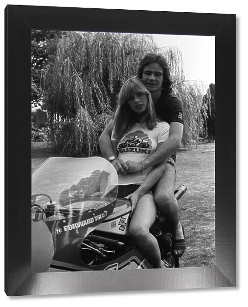 Motorcycle racer Barry Sheene at home with girlfriend 1976 Stephanie McLean sitting