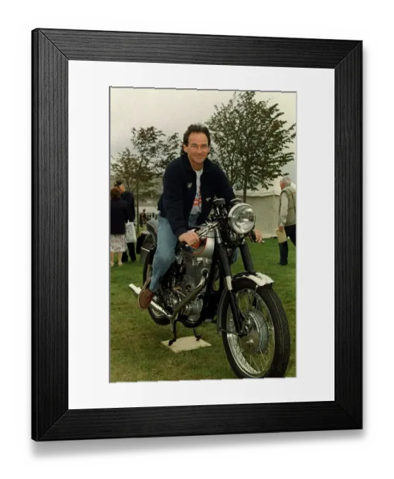 Framed Print : Barry Sheene September 1998. Former world motorcycle champion sitting on an old Framed Print : Barry Sheene September 1998. Former world motorcycle champion sitting on an old