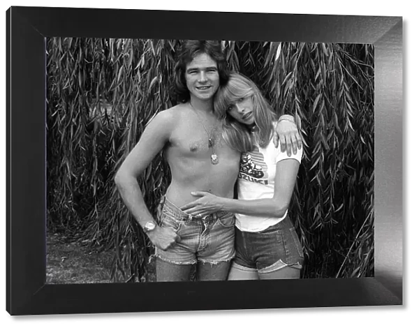 Motorcycle champion Barry Sheene at home with 1976 girlfriend Stephanie McLean in garden