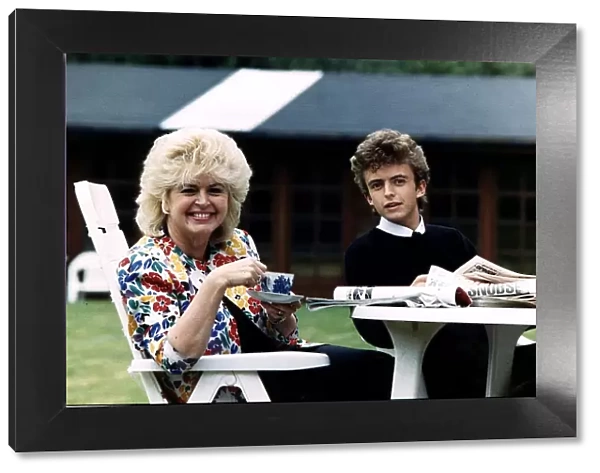 Gloria Hunniford TV and Radio Presenter with her son Michael sitting at a table drinking