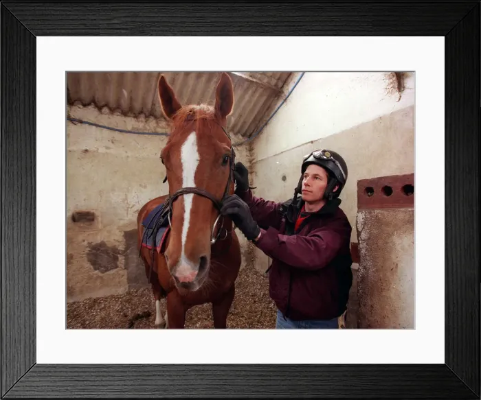 Framed Print : Jockey John McAuley cleaning bridle of the horse Serious Hurry in stables, June 1988 Framed Print : Jockey John McAuley cleaning bridle of the horse Serious Hurry in stables, June 1988