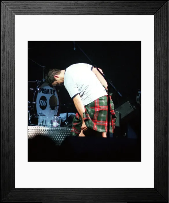 Framed Print : Robbie Williams wearing kilt starting to pull it up February 1999 during SECC concert