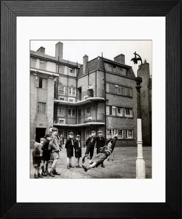 Framed Print : Evacuees returning from Leicestershire play in the street outside their tenement block in Framed Print : Evacuees returning from Leicestershire play in the street outside their tenement block in