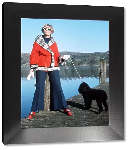 Tonia Campbell wife of Donald Campbell with poodle Coco watches as her husband