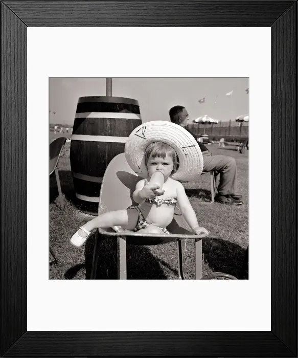 Framed Print : Butlins Holiday Camp at Bognor A Little toddler wearing a floral bikini sucking Framed Print : Butlins Holiday Camp at Bognor A Little toddler wearing a floral bikini sucking