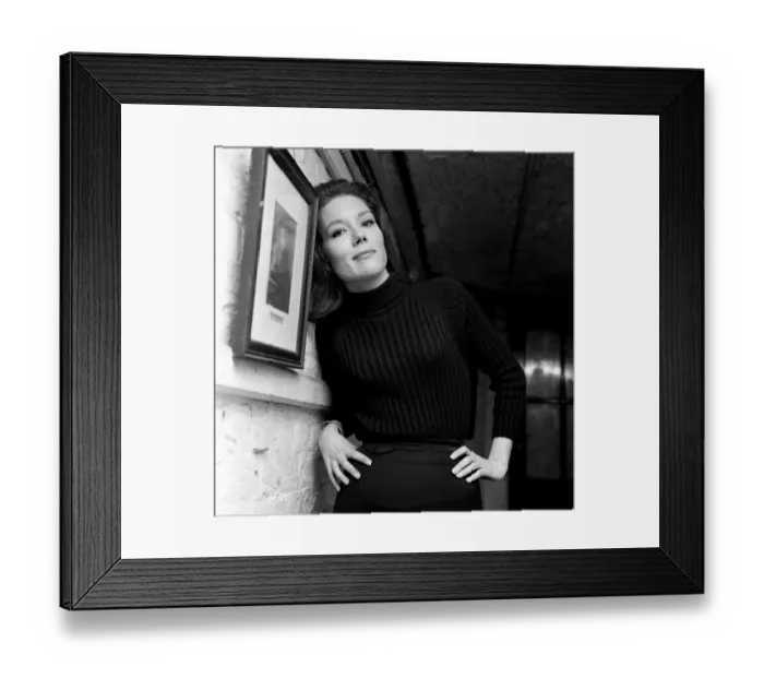 Framed Print : Actress Diana Rigg, star of The New Avengers, leaning against a wall with her hands