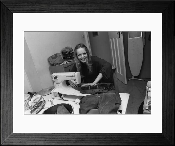 Framed Print : Model Twiggy at home using a sewing machine, 1974 vfr1