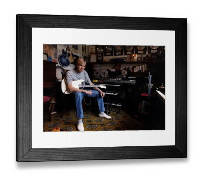 Framed Print : Justin Hayward lead singer of Moody Blues sits in his private recording studio at his