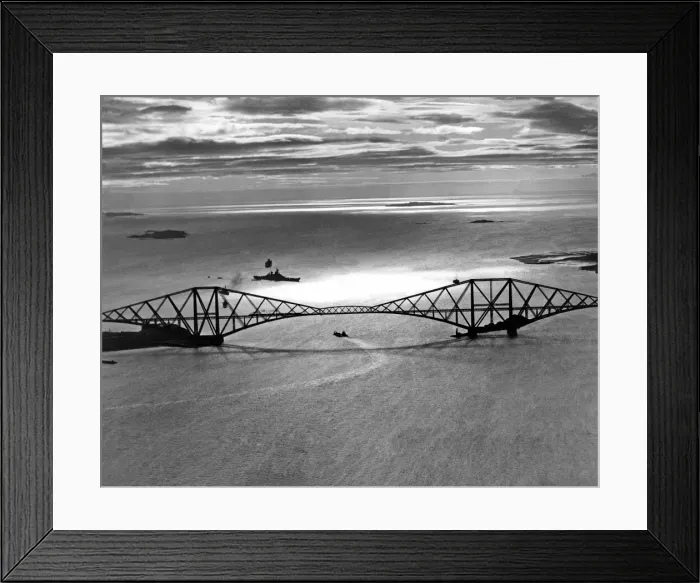 Framed Print : A Royal Navy battleships passes underneath the Forth bridges it prepares to dock