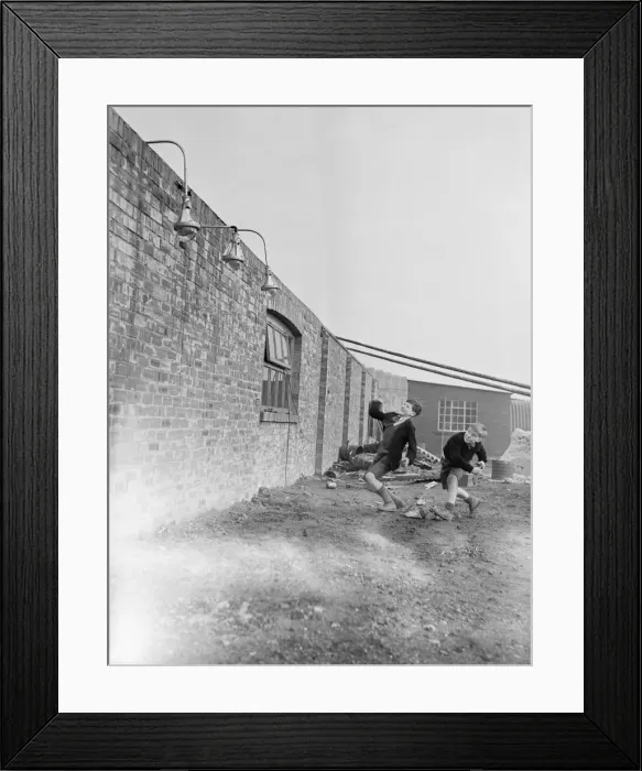 Framed Print : Children throwing bricks at new-type street lamp shades, which will not break Framed Print : Children throwing bricks at new-type street lamp shades, which will not break