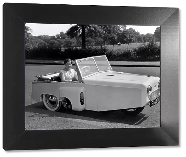 Model Pat Moss seen here in a Bond thre wheeled motor car. July 1955 P000004