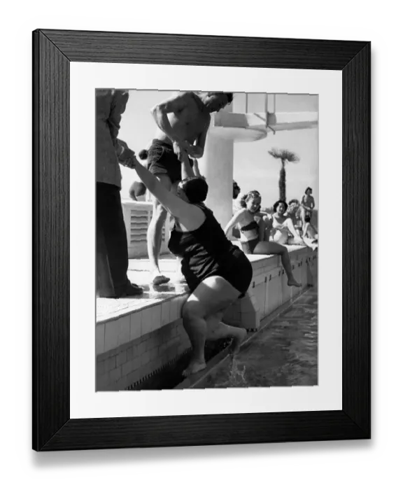 Framed Print : Helping Hands A large lady is helped out of the outdoor swimming pool at Plymouth Framed Print : Helping Hands A large lady is helped out of the outdoor swimming pool at Plymouth