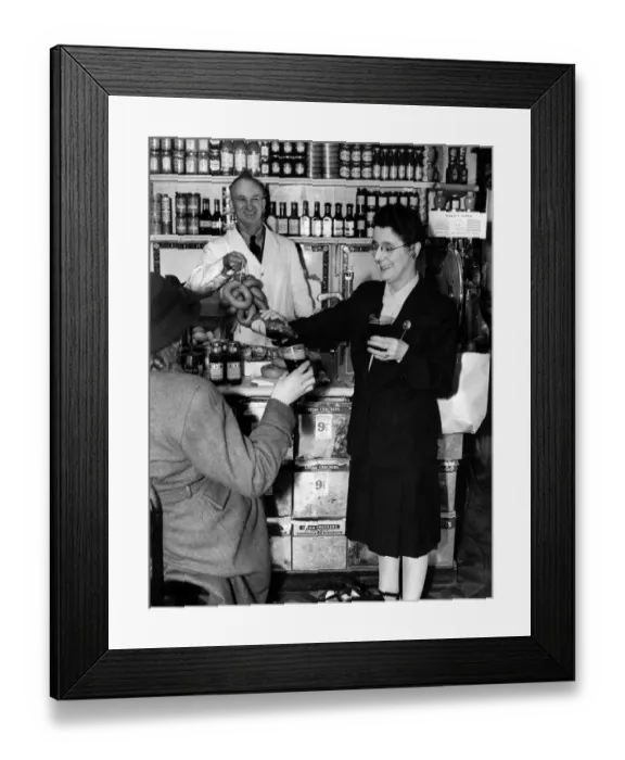 Framed Print : Sausages and Stout While shop assistant Carl Skinner brings out sausages for Framed Print : Sausages and Stout While shop assistant Carl Skinner brings out sausages for