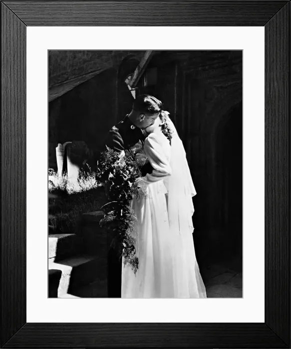 Framed Print : Bride and Groom snatch their first married kiss as they leave Stoke Damerel Church