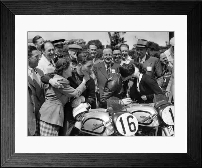 Framed Print : Geoff Duke (the winner) receives a congratulatory kiss from his wife Pat while the 2nd H