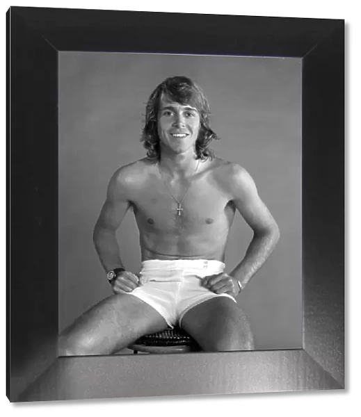 British tennis player John Lloyd, poses topless in the studio shortly before his 3rd
