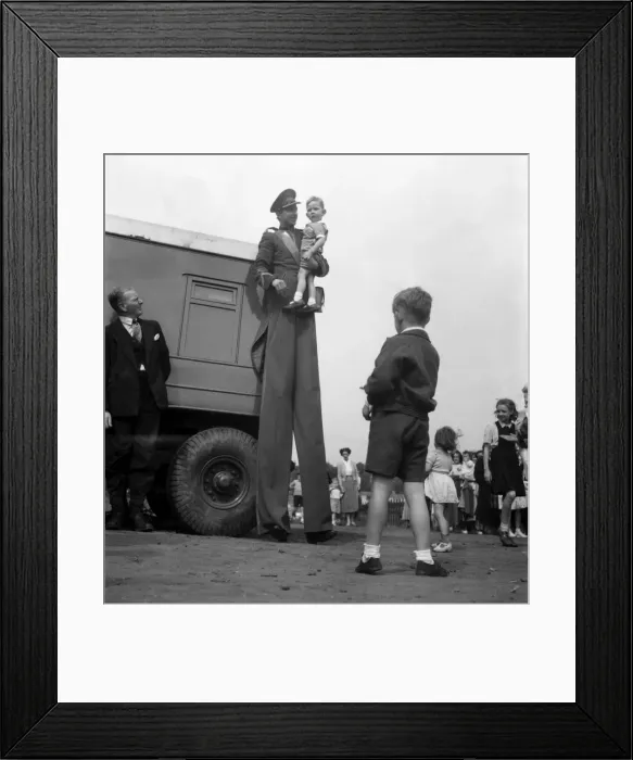 Framed Print : Entertainment : Circus Stilt Walker With Young Child. D3364 Framed Print : Entertainment : Circus Stilt Walker With Young Child. D3364