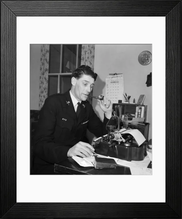 Framed Print : A worker for the RSPCA sitting at his desk typing his work and smoking a pipe Framed Print : A worker for the RSPCA sitting at his desk typing his work and smoking a pipe