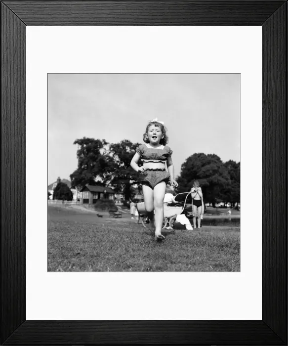 Framed Print : Holidays, little girl modelling swimsuit. June 1953 D3299-004 Framed Print : Holidays, little girl modelling swimsuit. June 1953 D3299-004