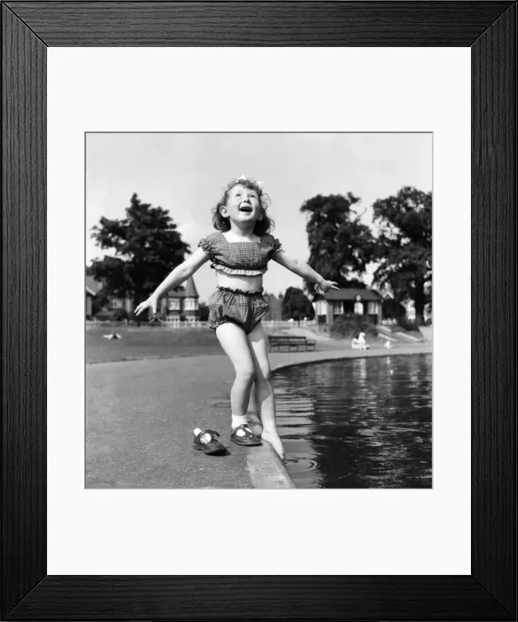 Framed Print : Holidays, little girl modelling swimsuit. June 1953 D3299-005