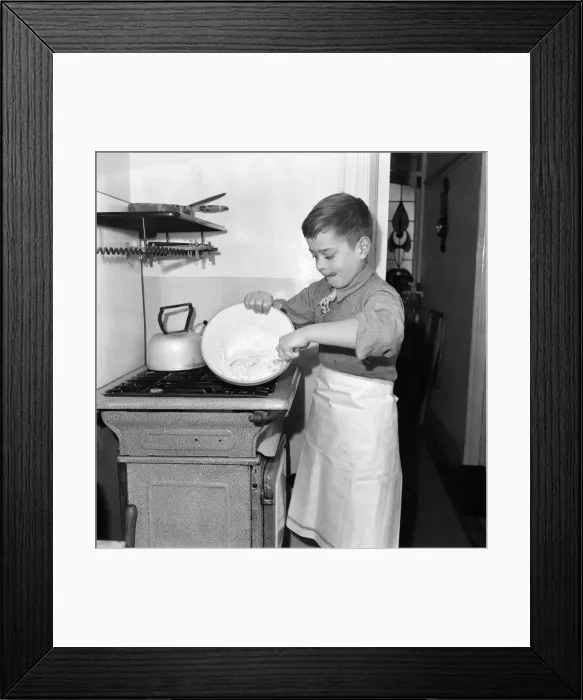 Framed Print : A young mixing ingredients together in a bowl in his kitchen at home. December 1952 C6055 Framed Print : A young mixing ingredients together in a bowl in his kitchen at home. December 1952 C6055