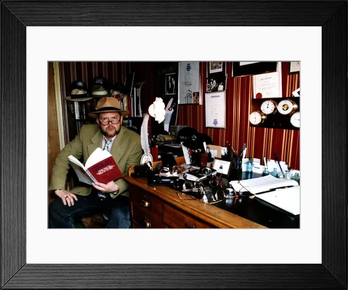Framed Print : James Whale TV and Radio Presenter Sitting at desk holding book Framed Print : James Whale TV and Radio Presenter Sitting at desk holding book