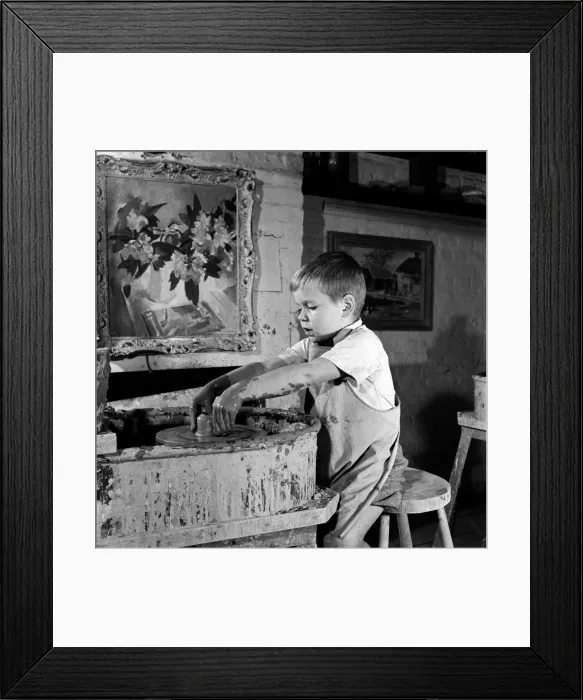 Framed Print : A child at the pottters wheels at David Rawnsleys Chelsea Studio Framed Print : A child at the pottters wheels at David Rawnsleys Chelsea Studio