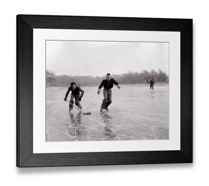 Framed Print : Weather Winter Scenes 1954 Two boys playing ice hockey on a frozen lake in winter