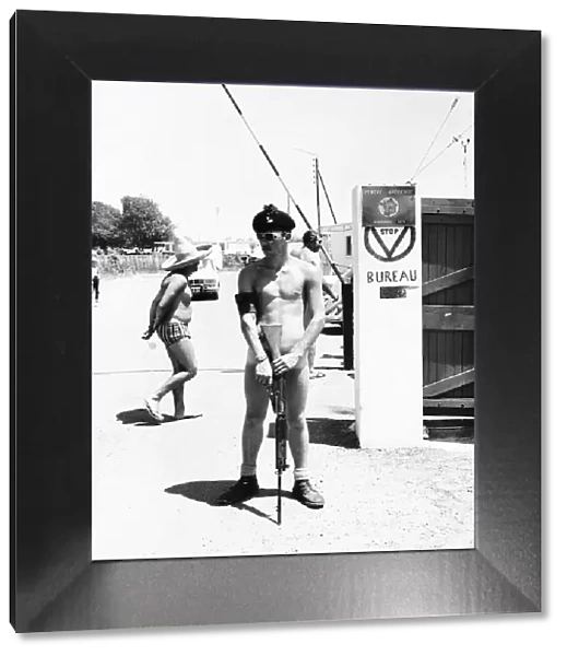 One of 1st Battalion Royal Irish Rangers on guard at the gates of the nudist camp next to
