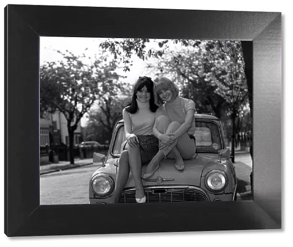 Actress Judy & Sally Geeson outside their home 1967 sitting on Mini motorcar