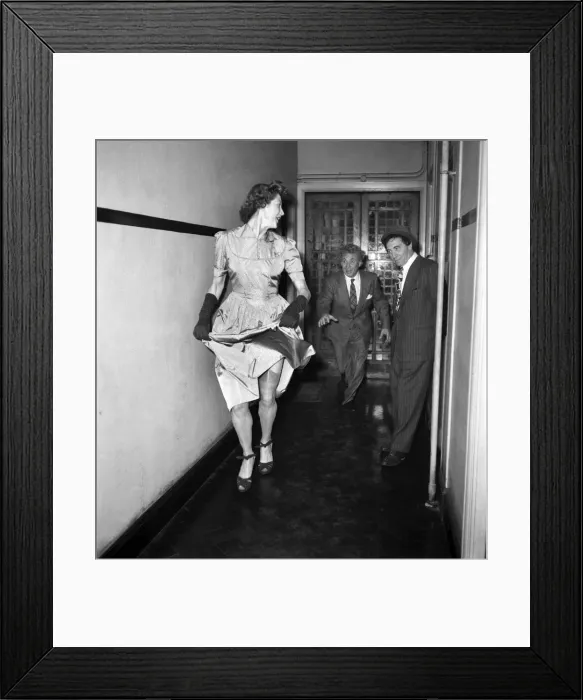 Framed Print : Marx Brothers. Harpo and Chico watching a woman walk by wearing a dress. May 1949 O18773 Framed Print : Marx Brothers. Harpo and Chico watching a woman walk by wearing a dress. May 1949 O18773
