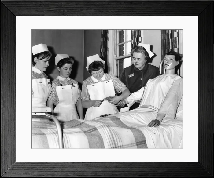 Framed Print : Sister Clark watches as, from left, Dorren Nichol, Emily Brown