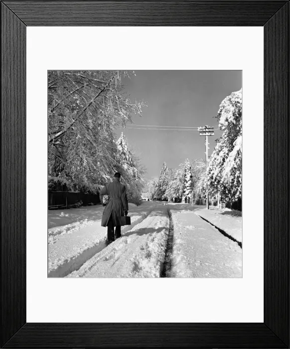 Framed Print : Man walks along a road covered in deep snow in Tadworth. April 1950 O23770-006