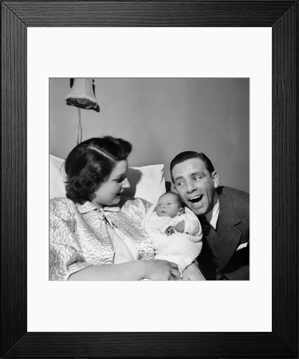Framed Print : Norman Wisdom with baby son Nicholas. March 1953 D1491 Framed Print : Norman Wisdom with baby son Nicholas. March 1953 D1491
