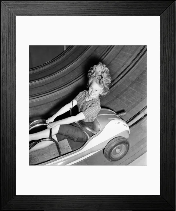 Framed Print : Fun fair - Jean Baker on one of the rides at the festival gardens Battersea. April 1953