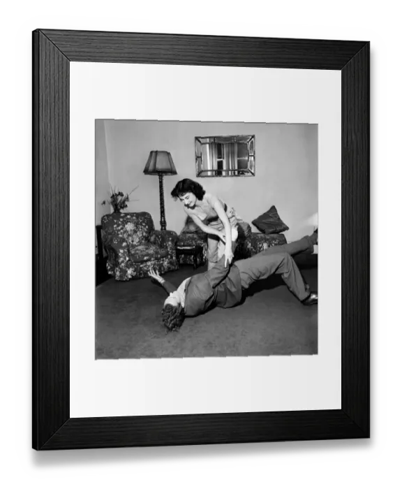Framed Print : Judo Girl throwing her husband over her shoulder in her living room Framed Print : Judo Girl throwing her husband over her shoulder in her living room