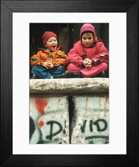 Framed Print : New Years Eve in Berlin Two children sitting on the Berlin Wall Framed Print : New Years Eve in Berlin Two children sitting on the Berlin Wall
