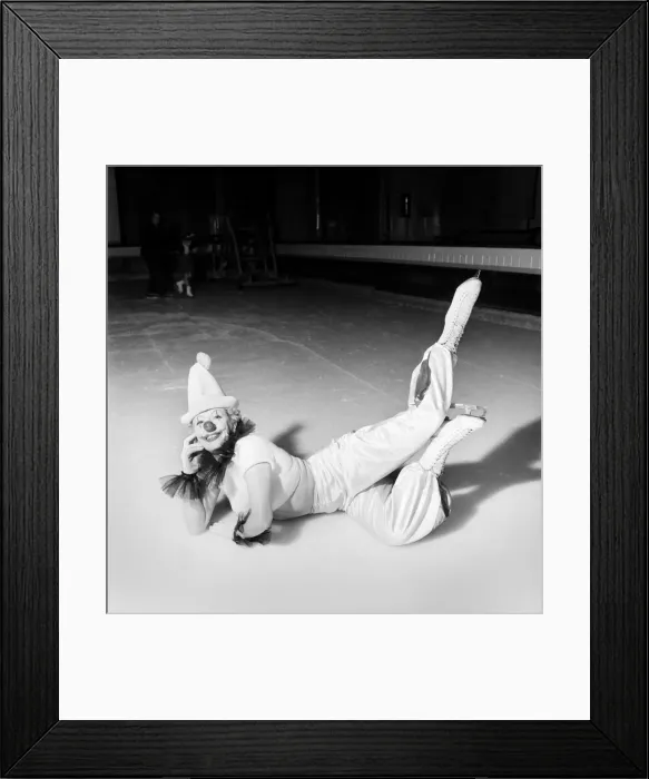 Framed Print : An Ice Skating female Clown performing, lying down. January 1953 D597-008 Framed Print : An Ice Skating female Clown performing, lying down. January 1953 D597-008