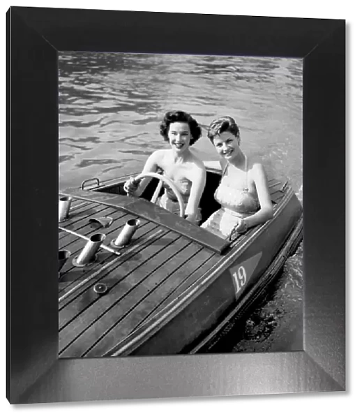 Holiday Two young women enjoying the boating pool at the Festival pleasure gardens