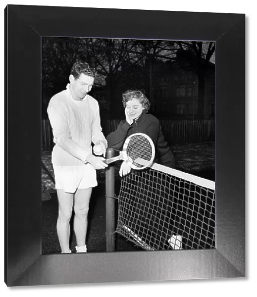 Man and woman talking after enjoying a game of tennis January 1953 D500