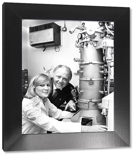 Richard Attenborough looks at an electron microscope with Junior technicain Margaret Mole