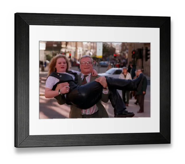Framed Print : Oliver Reed actor star of film The Bruce lifting young blonde woman Karen Bruce in his