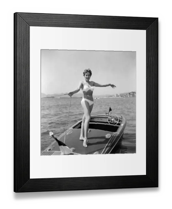 Framed Print : Cannes Film Festival 1953. Lise Michaud seen here modeling a bikini on a speed boat just