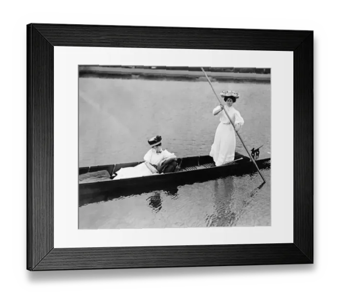: Fashion of 1919 with women in Edwardian dress punting on a lake Clothing : Fashion of 1919 with women in Edwardian dress punting on a lake Clothing