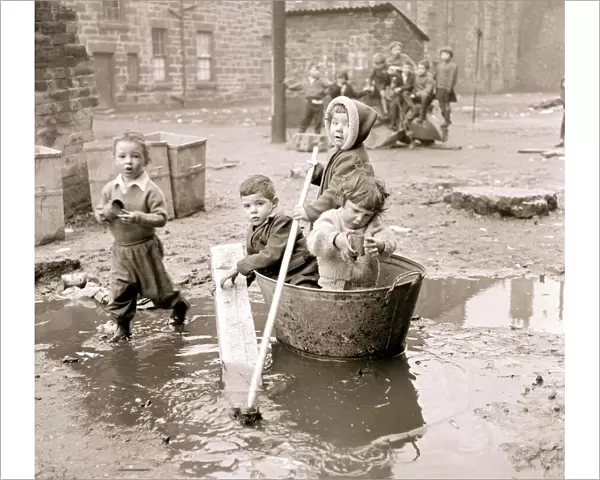 Housing slums in the Gorbals district of Glasgow where children use any materials to hand