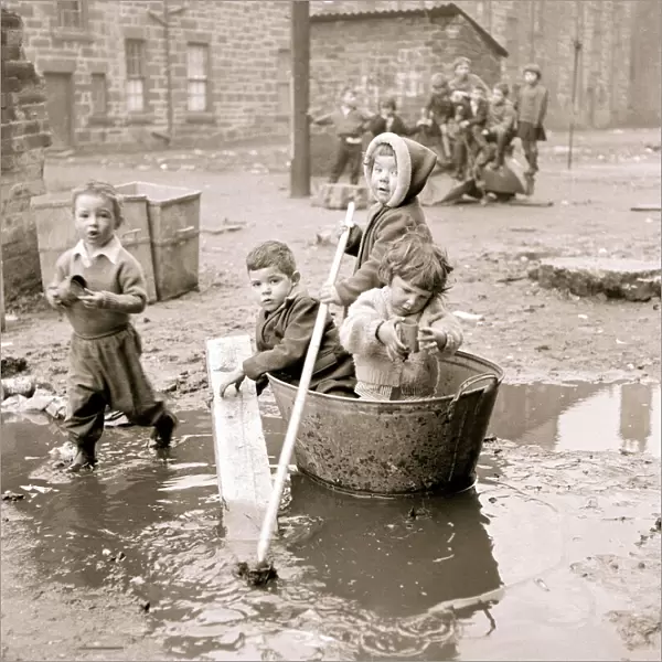 Housing slums in the Gorbals district of Glasgow where children use any materials to hand