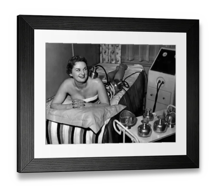 Framed Print : Beauty Clinic Model demonstrates the new electric pulse musle toning machice