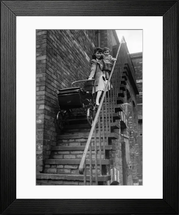 Framed Print : Mother and young child with pram walking down steps, highlight the dangers of bring up a Framed Print : Mother and young child with pram walking down steps, highlight the dangers of bring up a